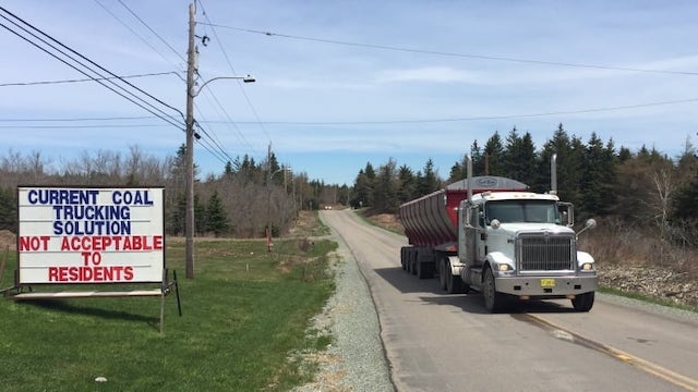 <i>Over the centre line, truck-hauling coal from Donkin Mine on Long Beach Road</i>